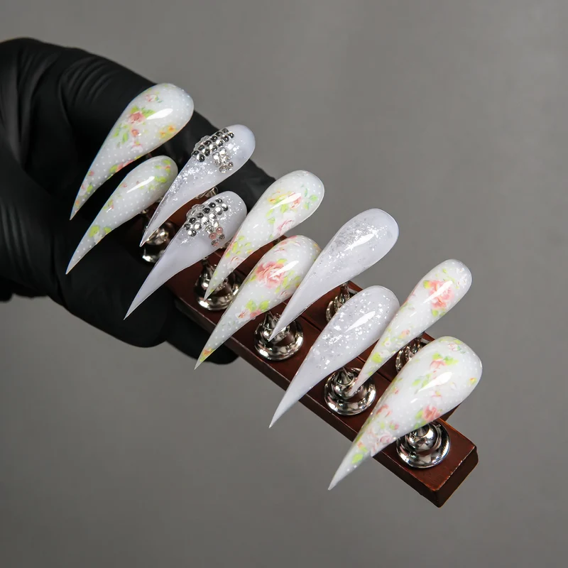 Elegantes Stiletto Press-On Nagelset mit Blumen- und Edelsteindetails