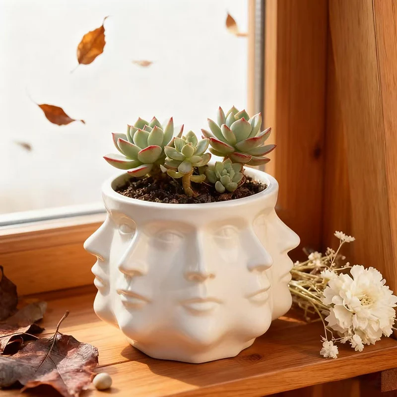 Moderner Blumentopf mit geometrischem Gesichtsmuster