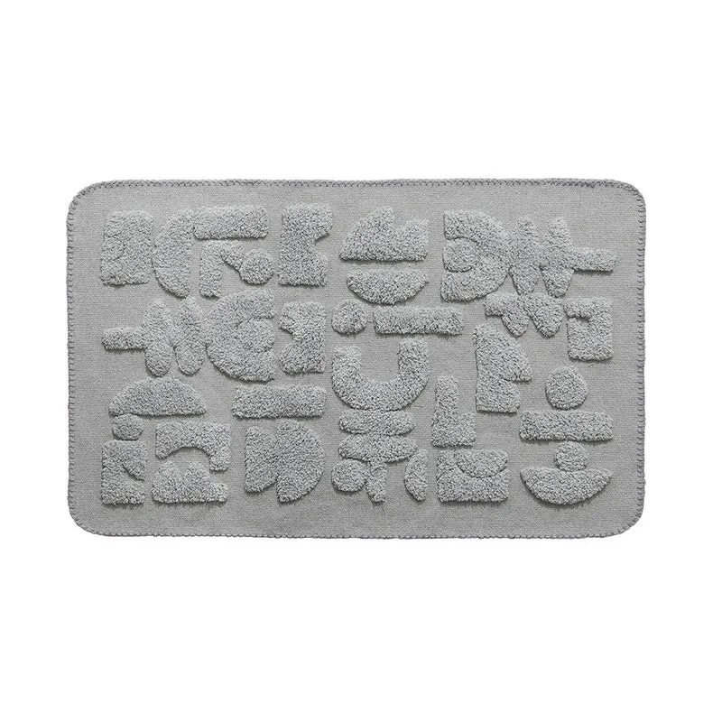 Rechteckige Baumwoll-Badematte mit abstraktem 3D‑Tuft‑Relief und rutschfester Rückseite