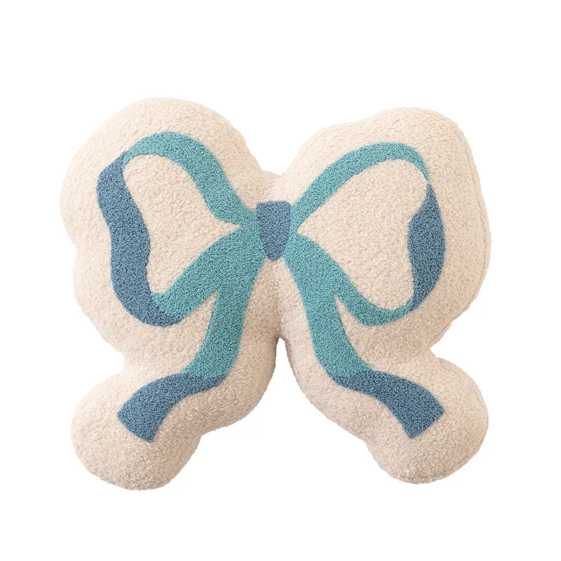 Schleifen-Dekokissen aus Bouclé mit flauschiger Teddy-Optik