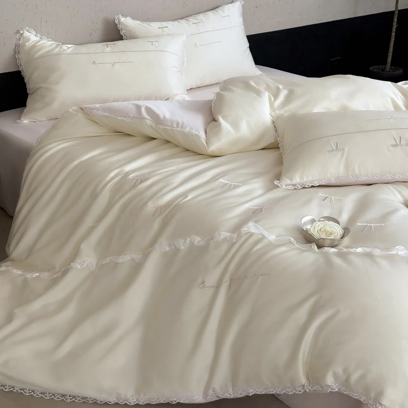 Elegante Bettwäschegarnitur aus seidig-feinem Satin mit bestickten Schleifen und Spitzenbordüre