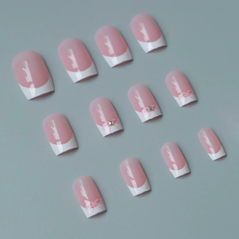 Elegantes French Tip Nagelkunstset mit zarten Schleifenakzenten