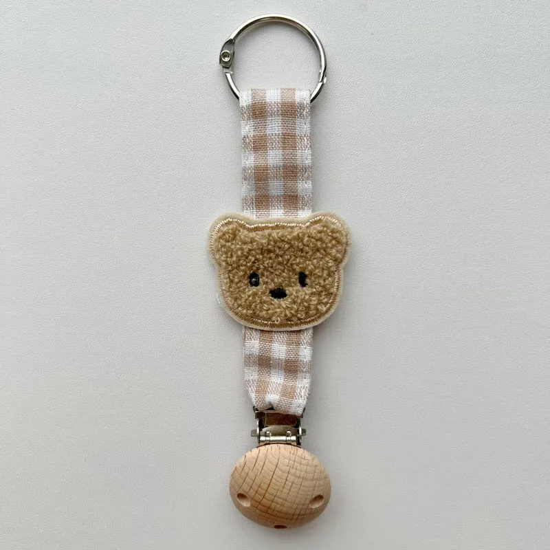 Handgefertigter Holz-Clip Schnullerhalter mit Gingham-Gurt und gepolstertem Blumenbeißring