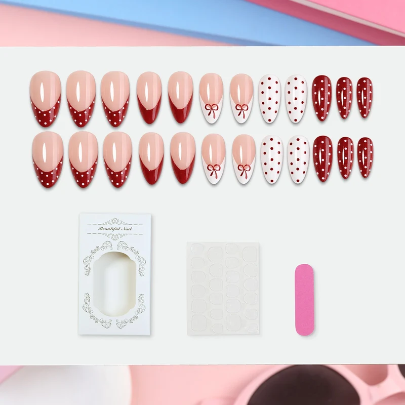 Kunstnagelset mit eleganten Schleifen- und Punkten Brehn