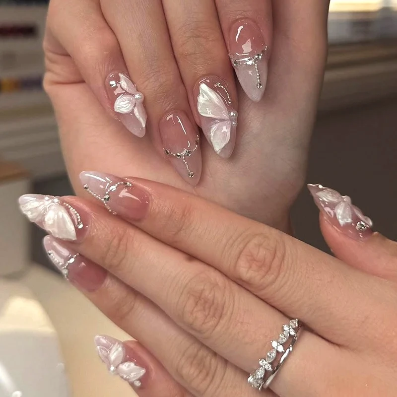 Künstliche Nägel mit zarten Schmetterlings-Design und Glitzerakzenten Brehn
