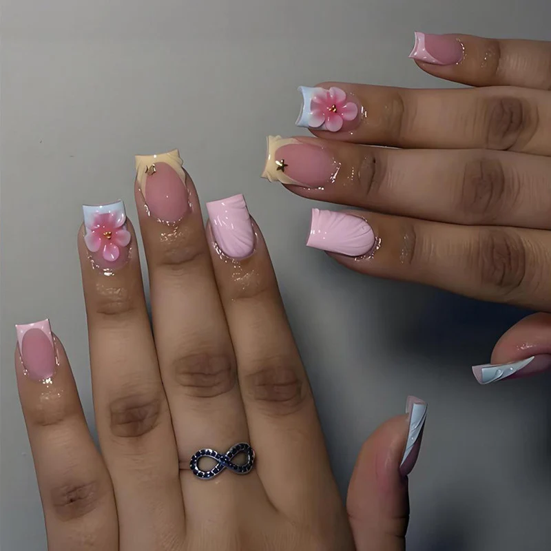 Kunstnagelset mit eleganten Blütenmotiven und farbenfrohen Designs Brehn